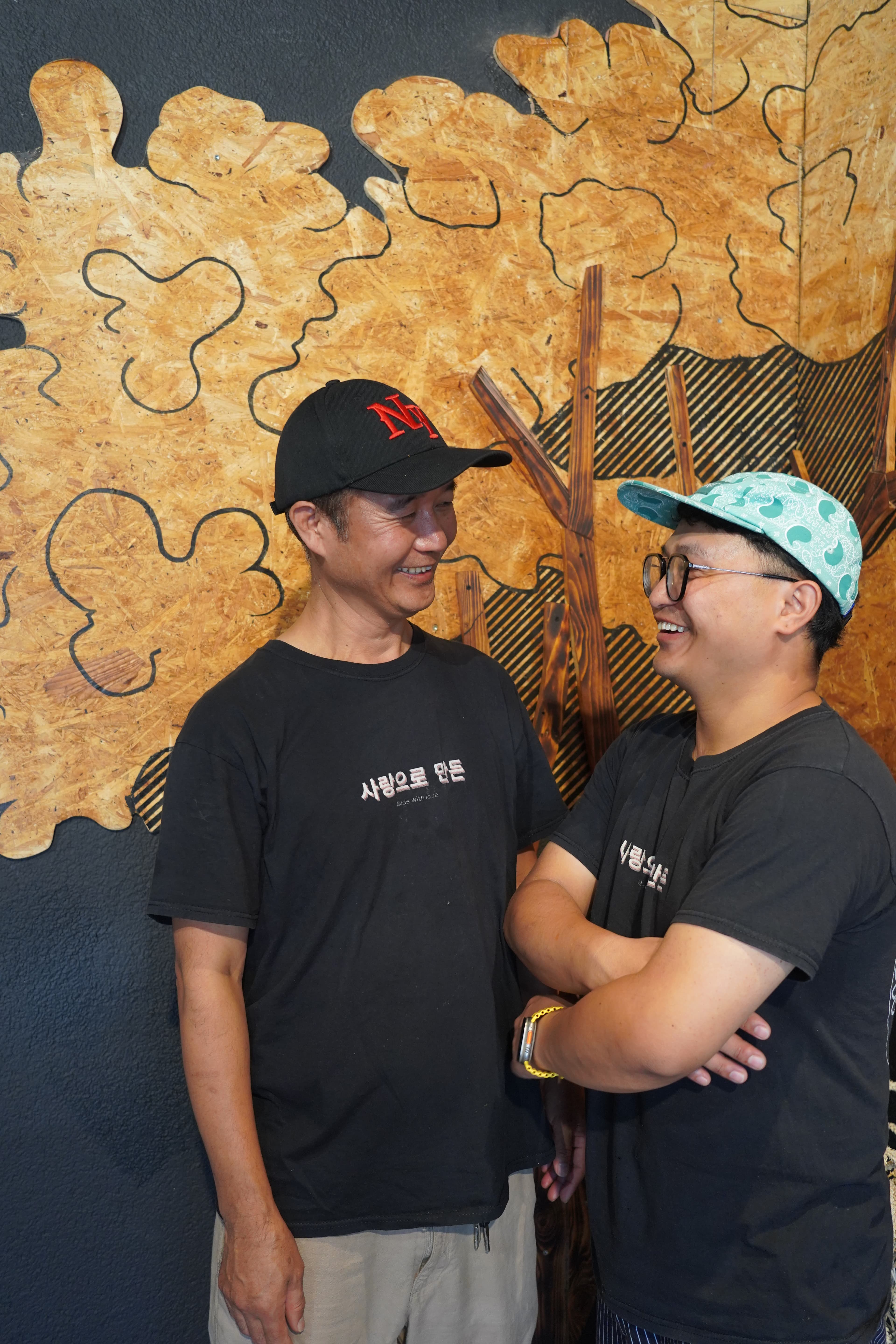 Two of the K-STREET crew in front of the golden mural